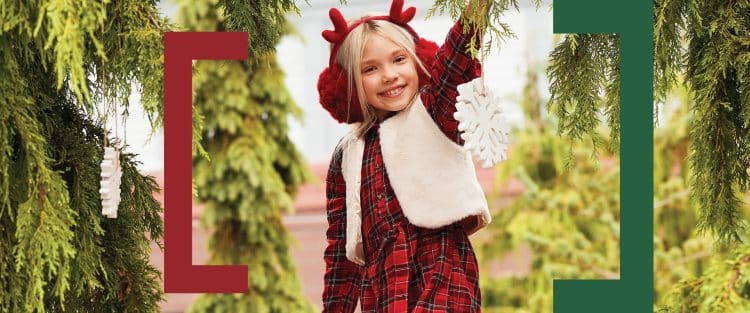 Holiday image of girl hanging an ornament